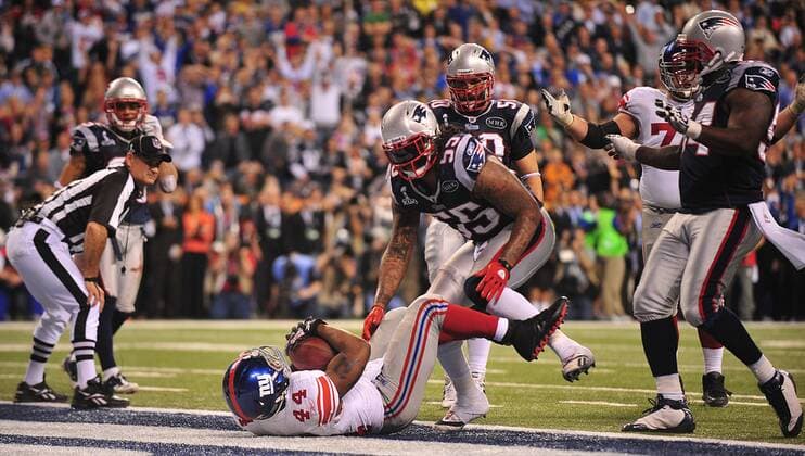 New York Giants running back Ahmad Bradshaw scores the game-winning touchdown on a 6-yard run in the fourth quarter against the New England Patriots at Super Bowl XLVI at Lucas Oil Stadium on February 5, 2012 in Indianapolis. The Giants beat the Patriots 21-17 to win Super Bowl XLVI..  SBP20120205376