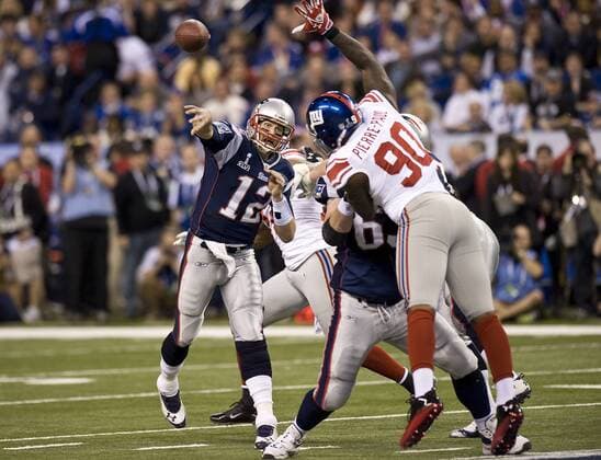 February 5, 2012: Patriots quarterback 12 Tom Brady throws a pass as Giants 90 Jason Pierre-Paul jumps to block during the New York Giants game versus the New England Patriots in Super Bowl XLVI at Lucas Oil Stadium in Indianapolis, Indiana. The Giants defeated the Patriots, 21-17. ALL NEW YORK NEWSPAPERS OUT ---- ALL NEW YORK NEWSPAPERS OUT NFL American Football Herren USA FEB 05 Super Bowl XLVI - Giants v Patriots Icon94212020530 EDITORIAL USE ONLY