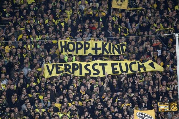 Hopp + Kind verpisst Euch! - Spruchband gegen Dietmar Hopp von Hoffenheim und Martin Kind von Hannover 96 auf Südtribüne Dortmund, während des Bundesligaspieles Borussia Dortmund gegen TSG 1899 Hoffenheim am 24.10.2010 in Dortmund. Blick auf die Südtribüne Dortmund.