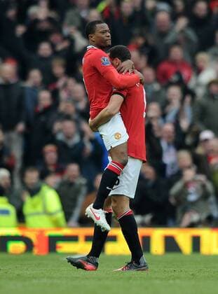 Football - Premier League - Manchester United vs. Liverpool Patrice Evra and Rio Ferdinand of Manchester United celebrate at the final whistle at Old Trafford, Manchester 
