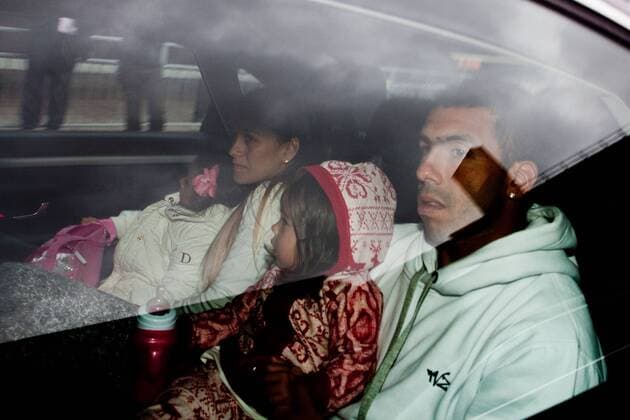 Feb. 14, 2012 - Manchester, England, UK - Carlos Tevez arrives with wife Vanesa and daughters Katia and Florencia at Manchester Airport to rejoin the Manchester City squad. He is surrounded by a large media scrum.  - ZUMAl94