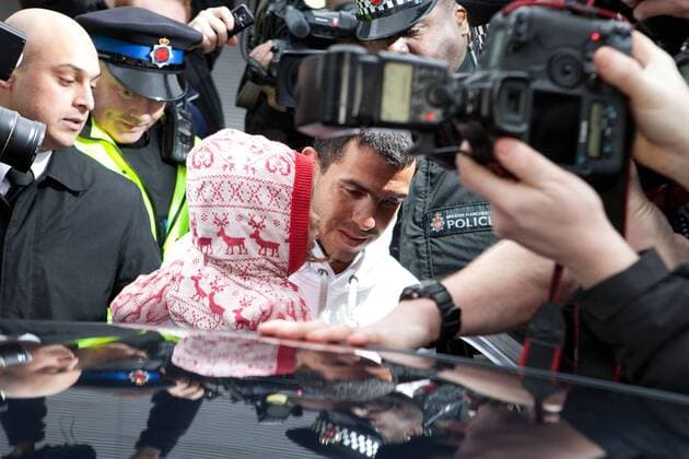 Feb. 14, 2012 - Manchester, England, UK - Carlos Tevez arrives with daughter Katia at Manchester Airport to rejoin the Manchester City squad. He is surrounded by a large media scrum.  - ZUMAl94