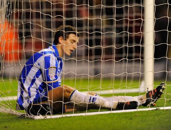 Lewis Dunk of Brighton closes his eyes in dejection after scoring an own goal..The FA Cup with Budweiser 5th Round match between.Liverpool FC vs Brighton & Hove Albion at Anfield, Liverpool on the .19th February 2012. EDITORIAL USE ONLY. No use with unauthorised audio, video, data, fixture lists, club league logos or live services. Online in-match use limited to 120 images, no video emulation. No use in betting, games or single club league player publications.