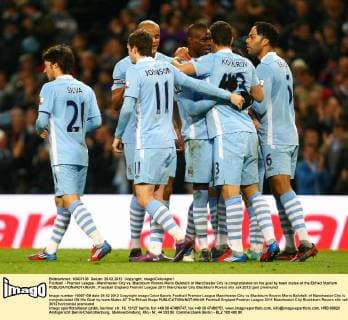 Football - Premier League - Manchester City vs. Blackburn Rovers Mario Balotelli of Manchester City is congratulated on his goal by team mates at the Etihad Stadium 