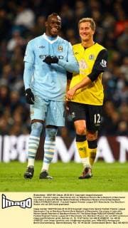 Football - Premier League - Manchester City vs. Blackburn Rovers Mario Balotelli of Manchester City shares a joke with Morten Gamst Pedersen of Blackburn Rovers at the Etihad Stadium 