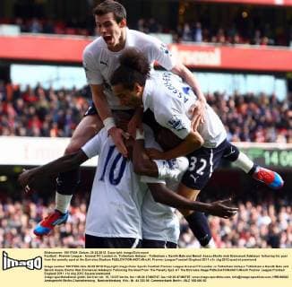 Football - Premier League - Arsenal FC London vs. Tottenham Hotspur - Tottenham s Gareth Bale and Benoit Assou-Ekotto mob Emmanuel Adebayor following his goal from the penalty spot at the Emirates Stadium 