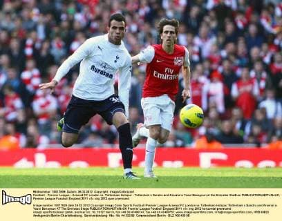 Football - Premier League - Arsenal FC London vs. Tottenham Hotspur - Tottenham s Sandro and Arsenal s Yossi Benayoun at the Emirates Stadium 