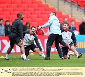 Englands Stuart Pearce shares a joke with Glen Johnson, Stewart Downing and Steven Gerrard during training..England Training at Wembley Stadium, London. 28th February 2012. EDITORIAL USE ONLY. No use with unauthorised audio, video, data, fixture lists, club league logos or live services. Online in-match use limited to 120 images, no video emulation. No use in betting, games or single club league player publications.