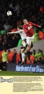 Luka Modric of Tottenham Hotspur goes up for the ball against Phil Jones of Manchester United during the Barclays Premiership Game between Tottenham Hotspur and Manchester United,at White Hart Lane in London, 2012. EDITORIAL USE ONLY. No use with unauthorised audio, video, data, fixture lists, club league logos or live services. Online in-match use limited to 120 images, no video emulation. No use in betting, games or single club league player publications. PC 01