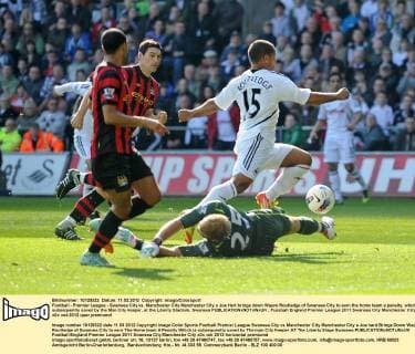 Football - Premier League - Swansea City vs. Manchester City Manchester City s Joe Hart brings down Wayne Routledge of Swansea City to earn the home team a penalty, which is subsequently saved by the Man City keeper, at the Liberty Stadium, Swansea 