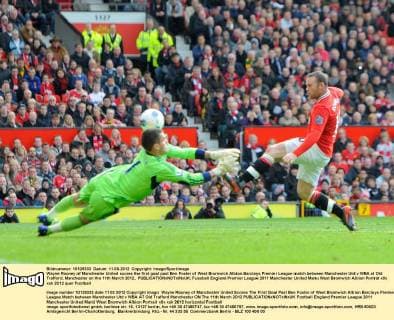 Wayne Rooney of Manchester United scores the first goal past Ben Foster of West Bromwich Albion.Barclays Premier League match between Manchester Utd v WBA at Old Trafford, Manchester on the 11th March 2012.. EDITORIAL USE ONLY. No use with unauthorised audio, video, data, fixture lists, club league logos or live services. Online in-match use limited to 120 images, no video emulation. No use in betting, games or single club league player publications.