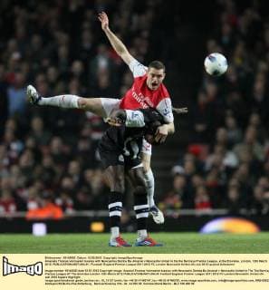 Arsenals Thomas Vermaelen tussles with Newcastles Demba Ba..Arsenal v Newcastle United in the the Barclays Premier League, at the Emirates, London. 12th March 2012. EDITORIAL USE ONLY. No use with unauthorised audio, video, data, fixture lists, club league logos or live services. Online in-match use limited to 120 images, no video emulation. No use in betting, games or single club league player publications.