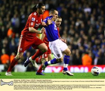 Football - Premier League - FC Liverpool vs. FC Everton Andy Carroll and Jay Spearing of Liverpool close in on Leon Osman of Everton at Anfield 
