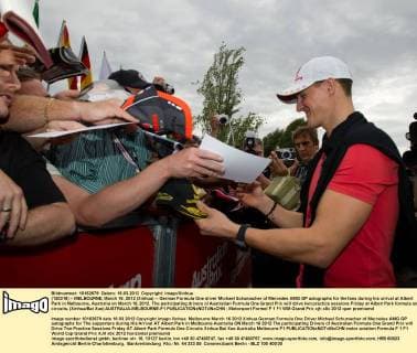(120316) -- MELBOURNE, March 16, 2012 (Xinhua) -- German Formula One driver Michael Schumacher of Mercedes AMG GP autographs for the fans during his arrival at Albert Park in Melbourne, Australia on March 16, 2012. The participating drivers of Australian Formula One Grand Prix will drive two practice sessions Friday at Albert Park formula one circuits. (Xinhua Bai Xue) AUSTRALIA-MELBOURNE-F1 