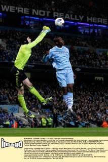 Manchester City s Mario Balotelli (R) in action with Chelsea s goalkeeper Petr Cech..Barclays Premier League match between Manchester City v Chelsea at the Etihad Stadium, Manchester on the 21st March 2012.. EDITORIAL USE ONLY. No use with unauthorised audio, video, data, fixture lists, club league logos or live services. Online in-match use limited to 120 images, no video emulation. No use in betting, games or single club league player publications.