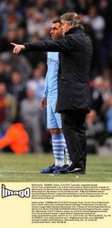 Carlos Tevez of Manchester City is given instructions by Roberto Mancini manager of Manchester City.Barclays Premier League match between Manchester City v Chelsea at Etihad Stadium, Manchester on the 21st March 2012.. EDITORIAL USE ONLY. No use with unauthorised audio, video, data, fixture lists, club league logos or live services. Online in-match use limited to 120 images, no video emulation. No use in betting, games or single club league player publications.