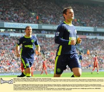 Shaun Maloney of Wigan Athletic (r) celebrates scoring the first goal Barclays Premier League match between Liverpool FC v Wigan Athletic at Anfield Stadium, Liverpool on the 24th March 2012 EDITORIAL USE ONLY. No use with unauthorised audio, video, data, fixture lists, club league logos or live services. Online in-match use limited to 120 images, no video emulation. No use in betting, games or single club league player publications.