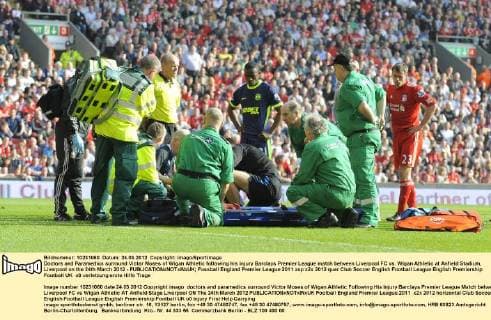 Doctors and Paramedics surround Victor Moses of Wigan Athletic following his injury Barclays Premier League match between Liverpool FC vs. Wigan Athletic at Anfield Stadium, Liverpool on the 24th March 2012 - EDITORIAL USE ONLY. No use with unauthorised audio, video, data, fixture lists, club league logos or live services. Online in-match use limited to 120 images, no video emulation. No use in betting, games or single club league player publications.