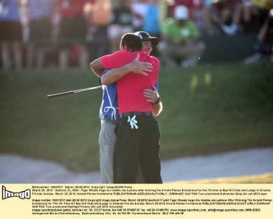 March 25, 2012 - Sanford, FL, USA - Tiger Woods hugs his caddie Joe LaCava after winning the Arnold Palmer Invitational for the 7th time at Bay Hill Club and Lodge in Orlando, Florida, Sunday, March 25, 2012. Arnold Palmer Invitational - ZUMAm67