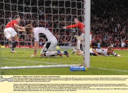 Wayne Rooney of Manchester United turns away to celebrate scoring the first goal.Barclays Premier League match between Liverpool v Wigan Athletic at Anfield Stadium, Liverpool on the 24th March 2012.. EDITORIAL USE ONLY. No use with unauthorised audio, video, data, fixture lists, club league logos or live services. Online in-match use limited to 120 images, no video emulation. No use in betting, games or single club league player publications.