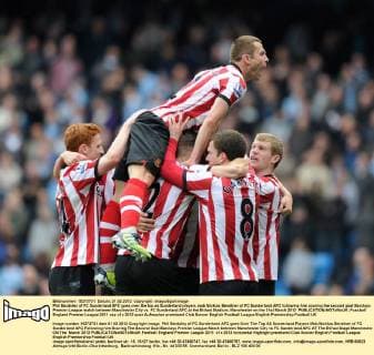 Phil Bardsley of FC Sunderland AFC goes over the top as Sunderland players mob Nicklas Bendtner of FC Sunderland AFC following him scoring the second goal Barclays Premier League match between Manchester City vs. FC Sunderland AFC at the Etihad Stadium, Manchester on the 31st March 2012 EDITORIAL USE ONLY. No use with unauthorised audio, video, data, fixture lists, club league logos or live services. Online in-match use limited to 120 images, no video emulation. No use in betting, games or single club league player publications.