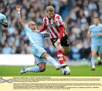 Nigel De Jong of Manchester City tackles James McClean of Sunderland Barclays Premier League match between Manchester City v AFC Sunderland at the Etihad Stadium, Manchester on the 31st March 2012 EDITORIAL USE ONLY. No use with unauthorised audio, video, data, fixture lists, club league logos or live services. Online in-match use limited to 120 images, no video emulation. No use in betting, games or single club league player publications.