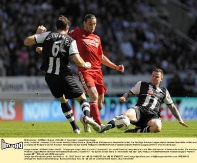 Andy Carroll of Liverpool (C) is closed down by Danny Guthrie (R) and Mike Williamson of Newcastle United The Barclays Premier League match between Newcastle United and Liverpool at the Sports Direct Arena at Newcastle 1st April 2012 EDITORIAL USE ONLY. No use with unauthorised audio, video, data, fixture lists, club league logos or live services. Online in-match use limited to 120 images, no video emulation. No use in betting, games or single club league player publications.