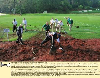 April 4, 2012 - Augusta, GA, USA - Groundskeepers hurry to clean up debris near Amen Corner at Augusta National Golf Club in Augusta, Georgia, Wednesday, April 4, 2012. An overnight storm dumped 1.4 inches of rain on the area, forcing the significant clean-up project on the final practice day prior to Thursday s start of The Masters. Practice for The Masters - ZUMAm67