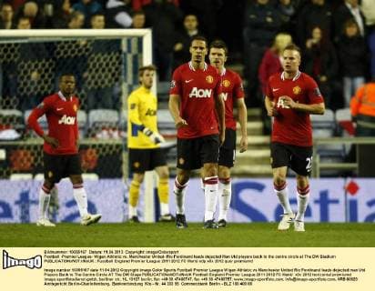 Football -Premier League- Wigan Athletic vs. Manchester United- Rio Ferdinand leads dejected Man Utd players back to the centre circle at The DW Stadium 