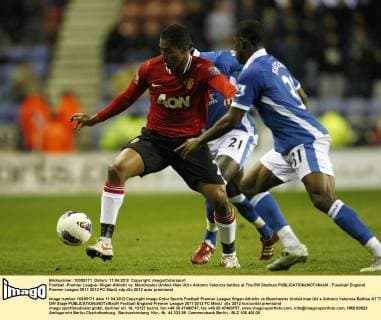 Football -Premier League- Wigan Athletic vs. Manchester United- Man Utd s Antonio Valencia battles at The DW Stadium 