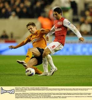 Football - Premier League - Wolverhampton Wanderers vs. Arsenal Kevin Doyle of Wolverhampton Wanderers fouls Arsenal s Mikel Arteta earning himself a yellow card at Molineux Stadium, Wolverhampton 