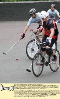 Bike polo players pedal for the reach of a street hockey ball during a bike polo game at The Pit at Sara D. Roosevelt Park in Manhattan, New York City, the United States, April 15, 2012. The was invented in Ireland in the 1890s. Today, it is played in more than 300 ciites worldwide. (Xinhua Zhai Xi) (jyc) US-NEW YORK-BIKE POLO 