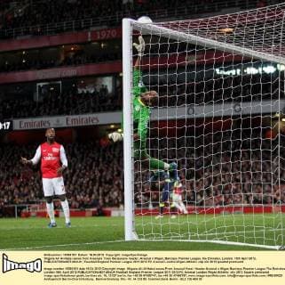 Wigans Ali Al-Habsi saves from Arsenals Yossi Benayouns header..Arsenal v Wigan, Barclays Premier League, the Emirates, London. 16th April 2012. EDITORIAL USE ONLY. No use with unauthorised audio, video, data, fixture lists, club league logos or live services. Online in-match use limited to 120 images, no video emulation. No use in betting, games or single club league player publications.
