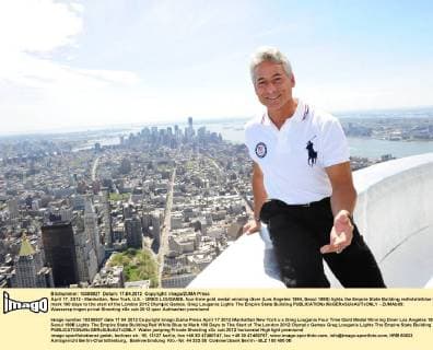 April 17, 2012 - Manhattan, New York, U.S. - GREG LOUGANIS, four-time gold medal winning diver (Los Angeles 1984, Seoul 1988) lights the Empire State Building red white blue to mark 100 days to the start of the London 2012 Olympic Games. Greg Louganis Lights The Empire State Building - ZUMAb09