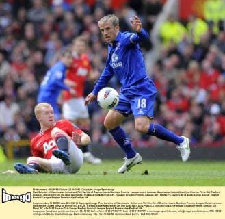 Paul Scholes of Manchester United and Phil Neville of Everton tussle.Barclays Premier League match between Manchester United (ManU) vs Everton FC at Old Trafford Stadium, Manchester on the 22nd April 2012. EDITORIAL USE ONLY. No use with unauthorised audio, video, data, fixture lists, club league logos or live services. Online in-match use limited to 120 images, no video emulation. No use in betting, games or single club league player publications.