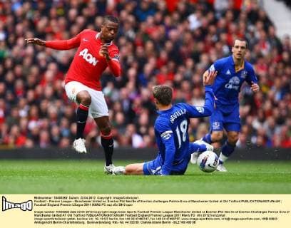 Football - Premier League - Manchester United vs. Everton Phil Neville of Everton challenges Patrice Evra of Manchester United at Old Trafford 