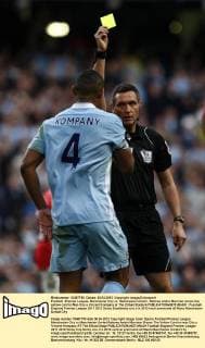 Football -Premier League- Manchester City vs. Manchester United - Referee Andre Marriner shows the yellow card to Man City s Vincent Kompany at The Etihad Stadium 