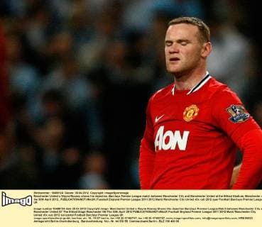 Manchester United s Wayne Rooney shows his dejection..Barclays Premier League match between Manchester City and Manchester United at the Etihad Stadium, Manchester on the 30th April 2012.. EDITORIAL USE ONLY. No use with unauthorised audio, video, data, fixture lists, club league logos or live services. Online in-match use limited to 120 images, no video emulation. No use in betting, games or single club league player publications.