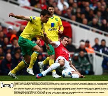 Football - Premier League - Arsenal FC London vs. Norwich City Robin Van Persie of Arsenal FC London in action against Russell Martin of Norwich City, at Emirates Stadium, London  3929-3929