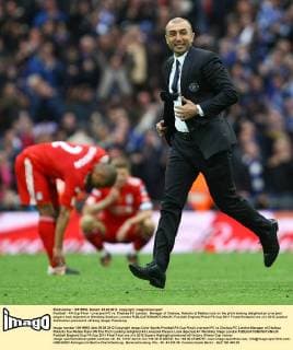 Football - FA Cup Final - Liverpool FC vs. Chelsea FC London; Manager of Chelsea, Roberto di Matteo runs on the pitch looking delighted as Liverpool players look dejected at Wembley Stadium, London 