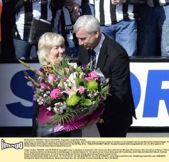 Lady Elsie is presented with flowers by Newcastle United manager Alan Pardew after unveiling a statue in memory of her husband and former Newcastle United manager Sir Bobby Robson at the Sports Direct Arena, Newcastle on the 6th May 2012 - EDITORIAL USE ONLY. No use with unauthorised audio, video, data, fixture lists, club league logos or live services. Online in-match use limited to 120 images, no video emulation. No use in betting, games or single club league player publications.