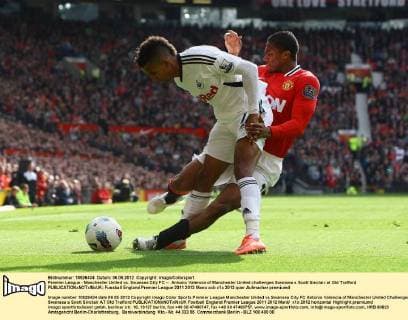 Premier League - Manchester United vs. Swansea City FC -- Antonio Valencia of Manchester United challenges Swansea s Scott Sinclair at Old Trafford 