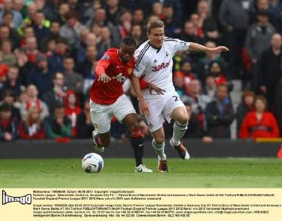 Premier League - Manchester United vs. Swansea City FC -- Patrice Evra of Manchester United and Swansea s Mark Gower battle at Old Trafford 