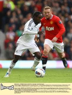 Premier League - Manchester United vs. Swansea City FC -- Wayne Rooney of Manchester United chases Swansea s Nathan Dyer at Old Trafford 