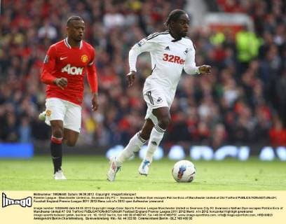 Premier League - Manchester United vs. Swansea City FC -- Swansea s Nathan Dyer escapes Patrice Evra of Manchester United at Old Trafford 