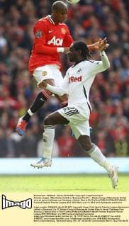 Premier League - Manchester United vs. Swansea City FC -- Ashley Young of Manchester United wins an aerial challenge over Swansea s Nathan Dyer at Old Trafford 