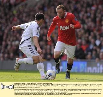 Wayne Rooney of Manchester United (ManU) tussles with Leon Britton of Swansea City.Barclays Premier League match Manchester Utd (ManU) vs. FC Swansea City at the Old Trafford Stadium, Manchester on the 6th May 2012. EDITORIAL USE ONLY. No use with unauthorised audio, video, data, fixture lists, club league logos or live services. Online in-match use limited to 120 images, no video emulation. No use in betting, games or single club league player publications.