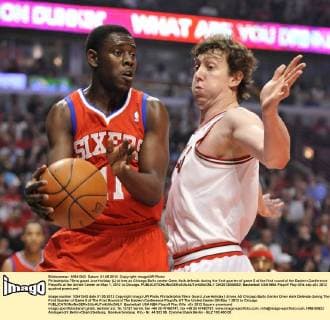 Philadelphia 76ers guard Jrue Holiday (L) drives as Chicago Bulls center Omer Asik defends during the first quarter of game 5 of the first round of the Eastern Conference Playoffs at the United Center on May 1, 2012 in Chicago.  CHI2012050802