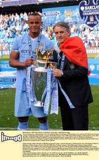Vincent Kompany of Manchester City with Roberto Mancini manager of Manchester City and the 2012 Barclays Premier League Trophy.Barclays Premier League match Manchester City v QPR at the Etihad Stadium, Manchester on the 13th May 2012. EDITORIAL USE ONLY. No use with unauthorised audio, video, data, fixture lists, club league logos or live services. Online in-match use limited to 120 images, no video emulation. No use in betting, games or single club league player publications.