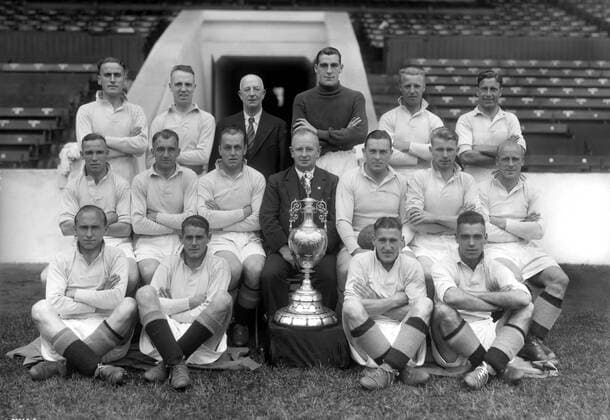 Football - Manchester City Team Group - League Champions 1936 37 Season Back, l-r: Keillor McCullough, William (Billy) Dale, Tom Chorlton (trainer), Frank Swift, Bobby Marshall, John (Jackie) Bray. Sitting: Ernest (Ernie) Toseland, Alex Herd, Fred Tilson, Mr Wilf Wild (Manager), Sam Barkas, Peter Doherty, Eric Brook. Ground: James Arthur (Jimmy) Heale, Charles (Colin) Rodger (Division 1 trophy) Gordon Vincent Clark, John Percival. 